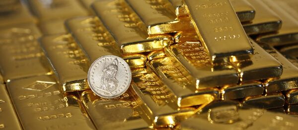 Gold bars and a Swiss Franc coin are seen in this illustration picture taken at the Austrian Gold and Silver Separating Plant 'Oegussa' in Vienna November 7, 2014 - Sputnik Mundo