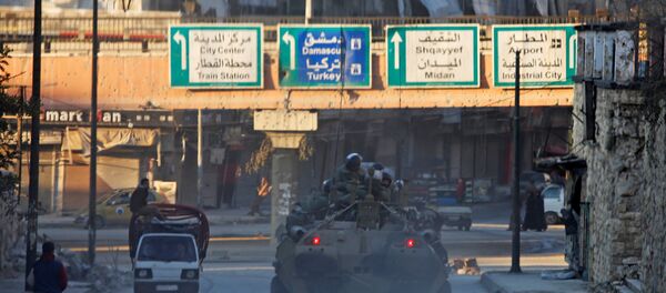 Russian soldiers, on armoured vehicles, patrol a street in Aleppo, Syria - Sputnik Mundo