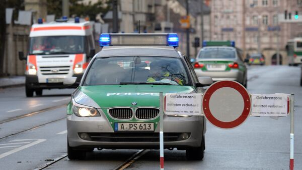 Police cars are seen beside a road block on an empty street in Augsburg, southern Germany Police cars are seen beside a road block on an empty street in Augsburg, southern Germany - Sputnik Mundo