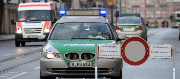 Police cars are seen beside a road block on an empty street in Augsburg, southern Germany - Sputnik Mundo