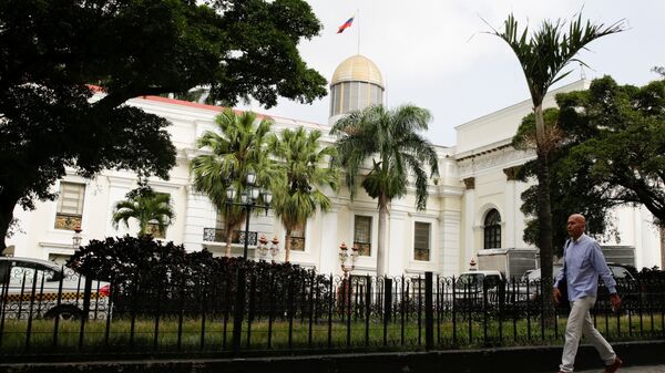 A man walks past the building of the National Assembly in Caracas, Venezuela - Sputnik Mundo