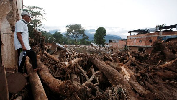 A man looks at a destroyed area after heavy rains caused several rivers to overflow, pushing sediment and rocks into buildings and roads in Mocoa, Colombia April 1, 2017. - Sputnik Mundo