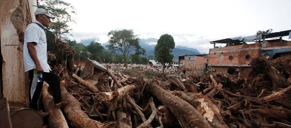 A man looks at a destroyed area after heavy rains caused several rivers to overflow, pushing sediment and rocks into buildings and roads in Mocoa, Colombia April 1, 2017. - Sputnik Mundo