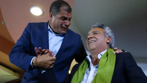 Ecuadorean presidential candidate Lenin Moreno is greeted by Ecuador's President Rafael Correa while waiting for the results of the national election in a hotel, in Quito