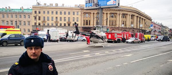 Emergency vehicles and a helicopter are seen at the entrance to Technological Institute metro station in Saint Petersburg on April 3, 2017 - Sputnik Mundo