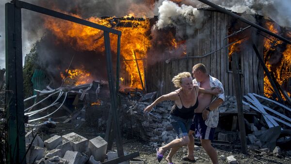 Lugareños de Stanitsa Lugánskaya huyen del incendio producido por un ataque de la Fuerza Aérea de Ucrania, 2 de julio de 2014 - Sputnik Mundo