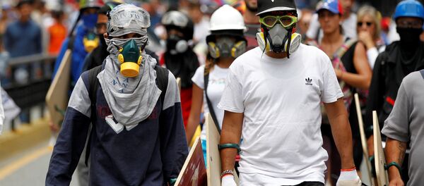 Los manifestantes en Venezuela - Sputnik Mundo
