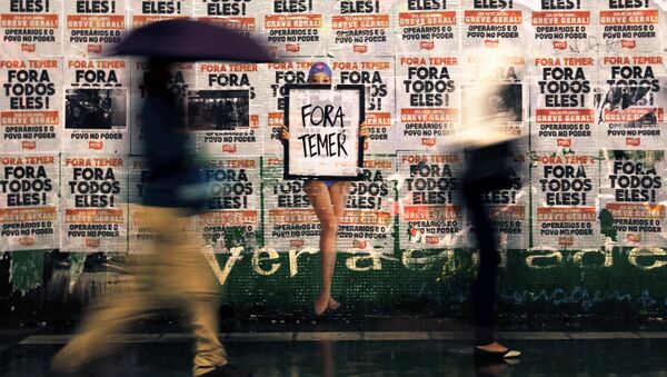 People walk past a sign reading Out Temer - Sputnik Mundo