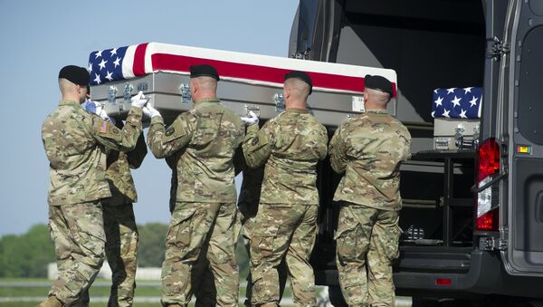 Un equipo de transporte del Ejército de EEUU coloca una caja que contiene los restos de su colega - Sputnik Mundo