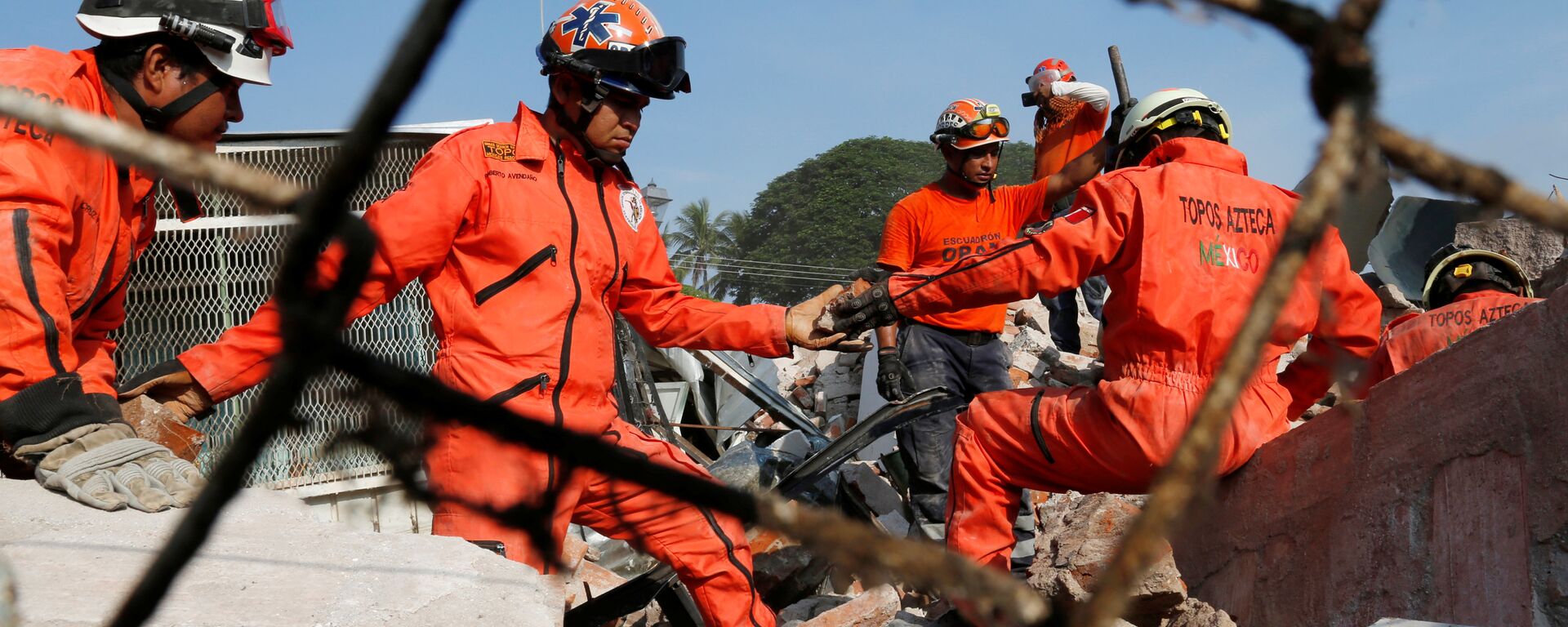 Rescue workers know as Topos Azteca clear the debris of a building damaged in an earthquake that struck the southern coast of Mexico - Sputnik Mundo, 1920, 28.06.2021