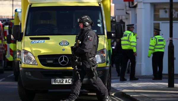 Un policía junto al equipo de emergencia en Londres, el Reino Unido Un policía junto al equipo de emergencia en Londres, el Reino Unido - Sputnik Mundo