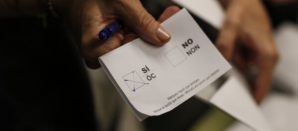 Una mujer muestra su boleta con la casilla Sí marcada en la Escuela Concepcio de Barcelona el 1 de octubre de 2017 - Sputnik Mundo