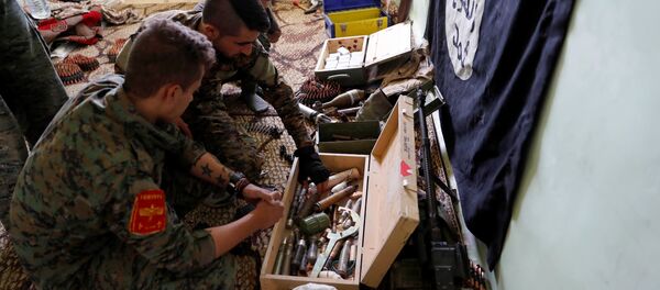 Los militares de Fuerzas Democráticas Sirias inspeccionan las armas de Daesh - Sputnik Mundo