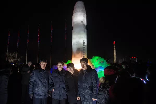 Norcoreanos se toman fotos frente a una enorme escultura de hielo inspirada en el misil balístico intercontinental norcoreano Hwasong-15, Pyongyang (Corea del Norte), el 1 de enero de 2018 - Sputnik Mundo