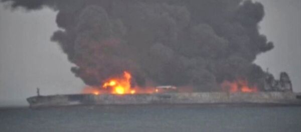 Smoke and fire is seen from Panama-registered tanker SANCHI carrying Iranian oil after it collided with a Chinese freight ship in the East China Sea, in this still image taken from a January 7, 2018 video - Sputnik Mundo