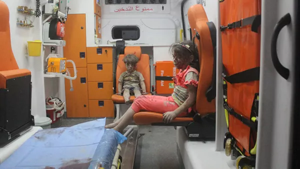 5-year-old Omran Daqneesh and his sister sit in an ambulance after being pulled out of a building hit by an airstrike in Aleppo, Syria, on Aug. 17, 2016