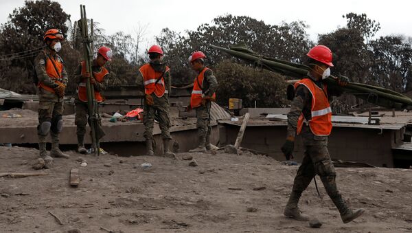 Rescatistas en un lugar afectado por la erupción del volcán de Fuego en San Juan Alotenango, Guatemala - Sputnik Mundo