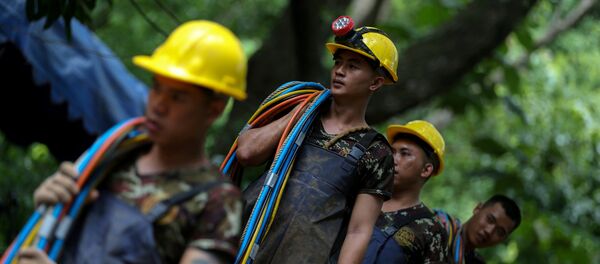 Socorristas tailandeses tras la evaciacion del grupo niños y su entrenador - Sputnik Mundo