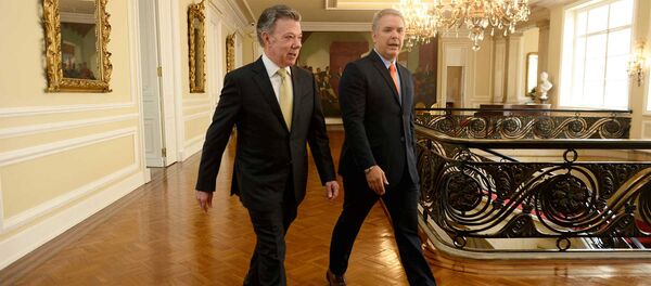 El presidente de Colombia, Juan Manuel Santos, y el presidente electo, Iván Duque - Sputnik Mundo