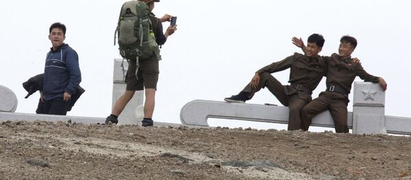 Una turista australiana hace una foto a dos soldados norcoreanos - Sputnik Mundo