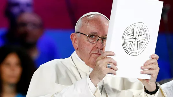 Pope Francis holds the Book of the Gospels as he meets Italian youth at the ancient Circo Massimo in Rome, Italy August 11, 2018