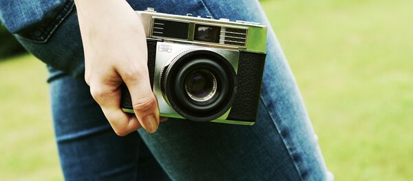 Una mujer con una cámara - Sputnik Mundo