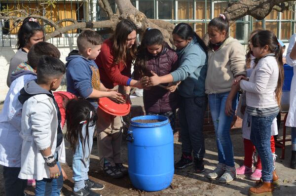 Alumnos del proyecto Entre bichitos preparando los Microorganismos Eficientes Nativos en la escuela montevideana República Popular China   - Sputnik Mundo