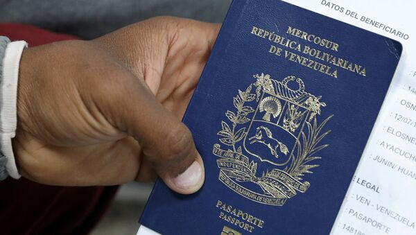 Un migrante venezolano muestra su pasaporte Un migrante venezolano muestra su pasaporte - Sputnik Mundo
