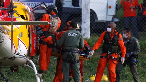 Cuerpo de la victima de la rotura de una represa en Brumadinho - Sputnik Mundo