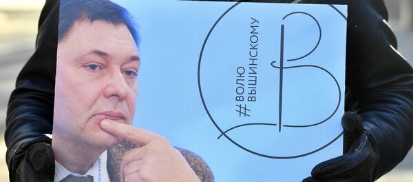 Un activista con la imagen del director del portal RIA Novosti Ukraina, Kiril Vishinski - Sputnik Mundo