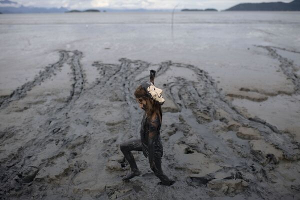 Un niño con una máscara en el festival de barro Bloco da Lama en Brasil. - Sputnik Mundo