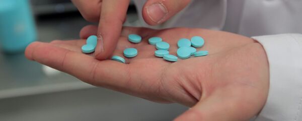 Una persona muestra medicamentos - Sputnik Mundo