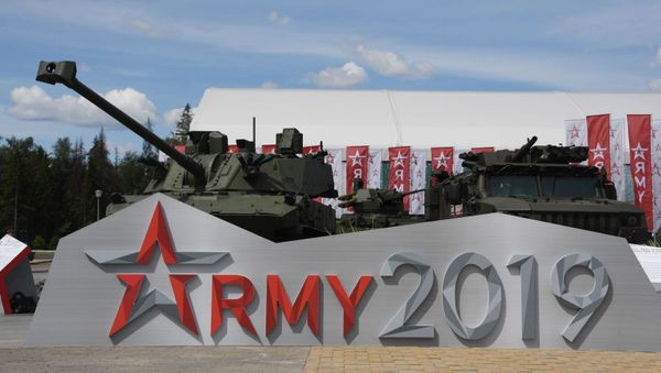 Un tanque y un vehículo militar detrás del logo Army 2019 Un tanque y un vehículo militar detrás del logo Army 2019 - Sputnik Mundo