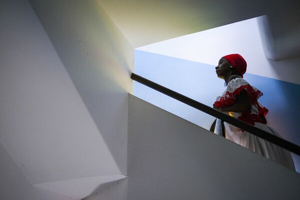 Una mujer sube al campanario de la Iglesia del pueblo durante la celebración de la misa del Día de San Juan Bautista en Curiepe. - Sputnik Mundo