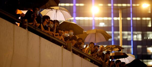 Manifestantes en un puente cerca de los edificios gubernamentales en Hong Kong Manifestantes en un puente cerca de los edificios gubernamentales en Hong Kong - Sputnik Mundo