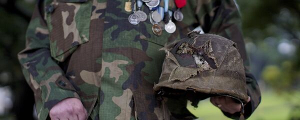 El veterano de la Guerra de las Malvinas muestra su casco dañado en el campo de batalla - Sputnik Mundo