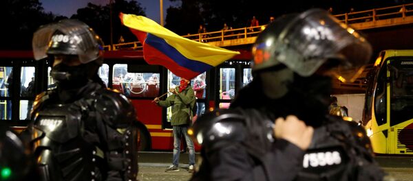 Policías colombianos custodian una calle de Bogotá frente a manifestantes - Sputnik Mundo