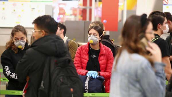 La gente con mascarillas durante el brote de coronavirus en Madrid, España - Sputnik Mundo