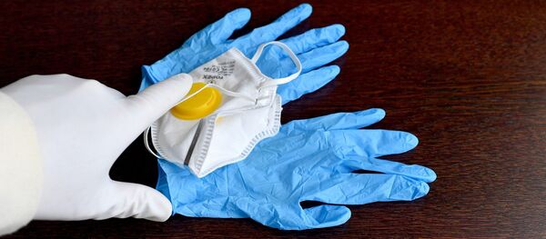 Una mascarilla y unos guantes para protegerse del coronavirus Una mascarilla y unos guantes para protegerse del coronavirus - Sputnik Mundo