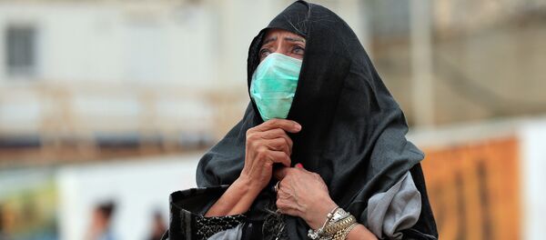 Una mujer con una mascarilla en Jerusalén Una mujer con una mascarilla en Jerusalén - Sputnik Mundo