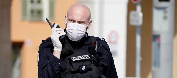 Un policía en mascarilla - Sputnik Mundo