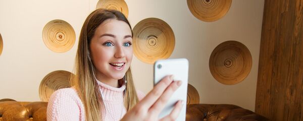 Una joven con un smartphone - Sputnik Mundo