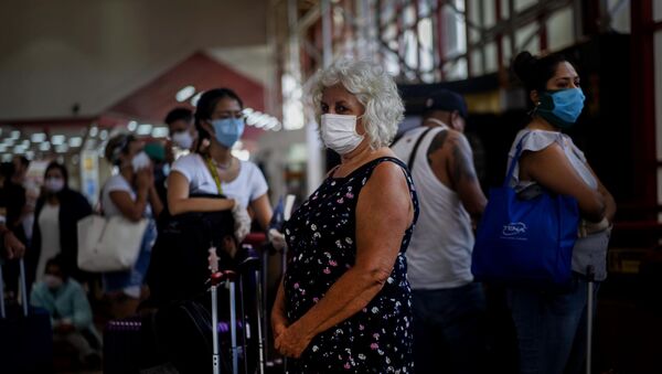 Una mujer con mascarilla - Sputnik Mundo