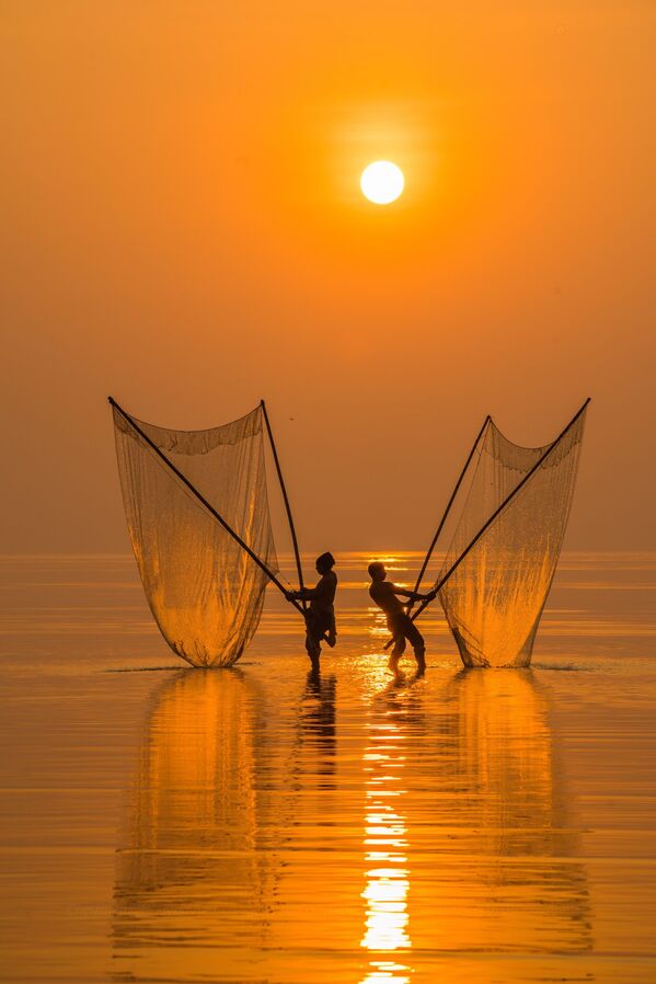 La foto 'Pescador bajo el amanecer', de un fotógrafo vietnamita, presentada en el concurso The World's Best Photos of #Water2020. - Sputnik Mundo