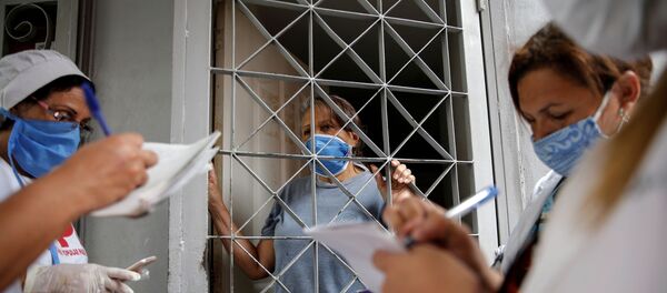 Médicos venezolanos y cubanos haciendo inspecciones de los ciudadanos de Caracas durante el brote del coronavirus en Venezuela - Sputnik Mundo