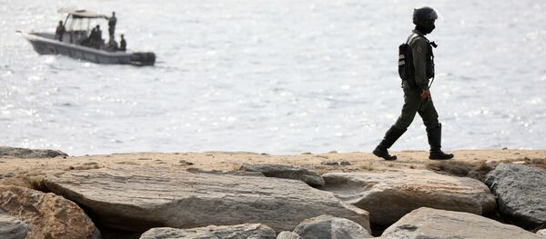 Un miembro de la Guardia Nacional Bolivariana camina sobre un rompeolas después de que el Gobierno de Venezuela anunciara una fallida incursión en Macuto - Sputnik Mundo