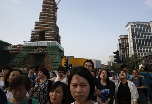 People walk in front of the Parisian Macao in Macau People walk in front of the Parisian Macao in Macau - Sputnik Mundo