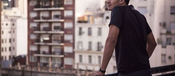 Hombre mirando la ciudad desde la terraza - Sputnik Mundo